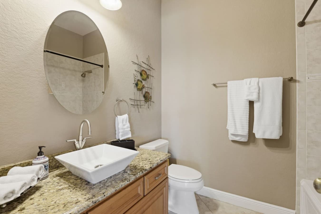 Clean and updated bathroom with modern finishes and fresh towels provided.