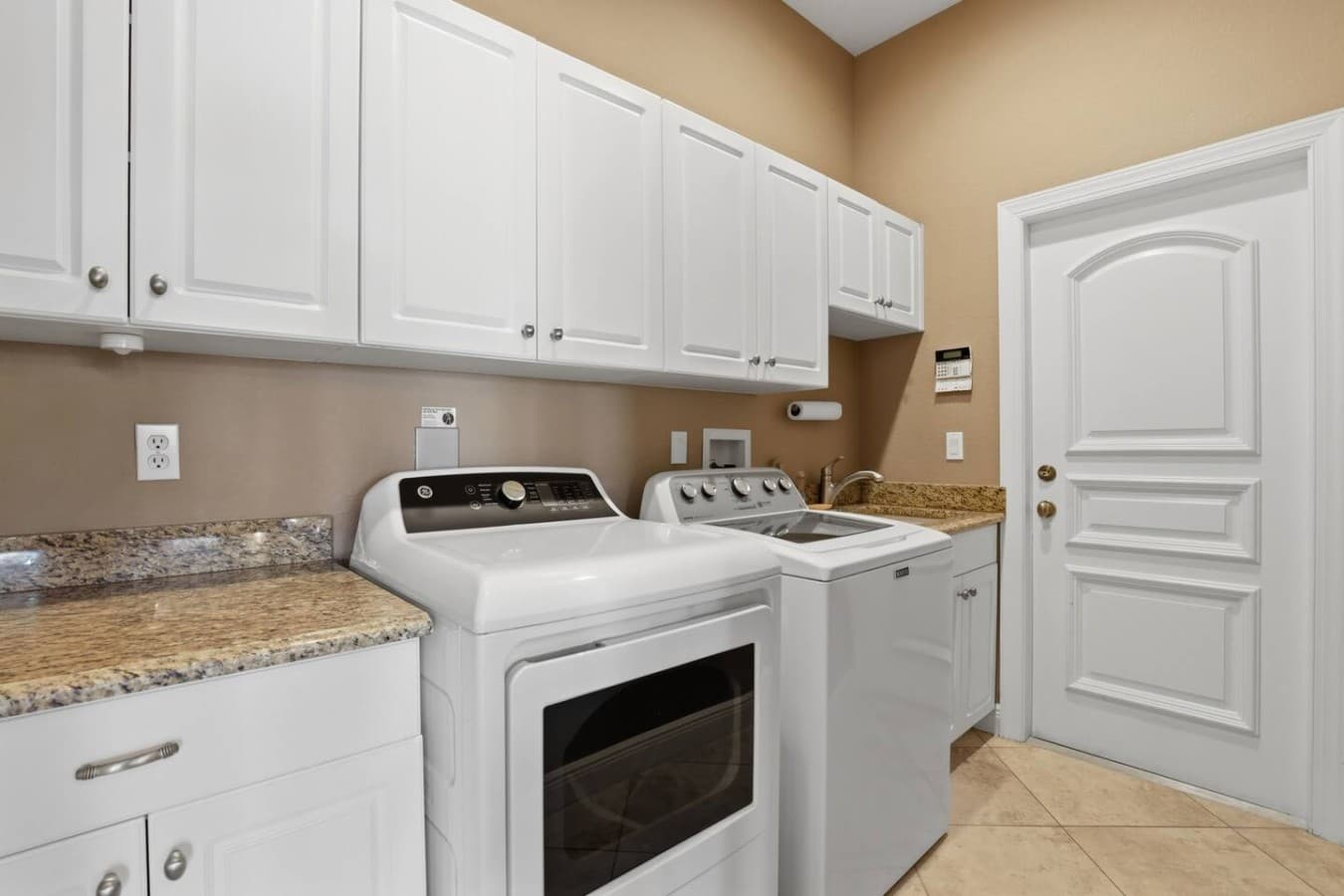 Full laundry room with washer, dryer, and extra storage available for guest use.