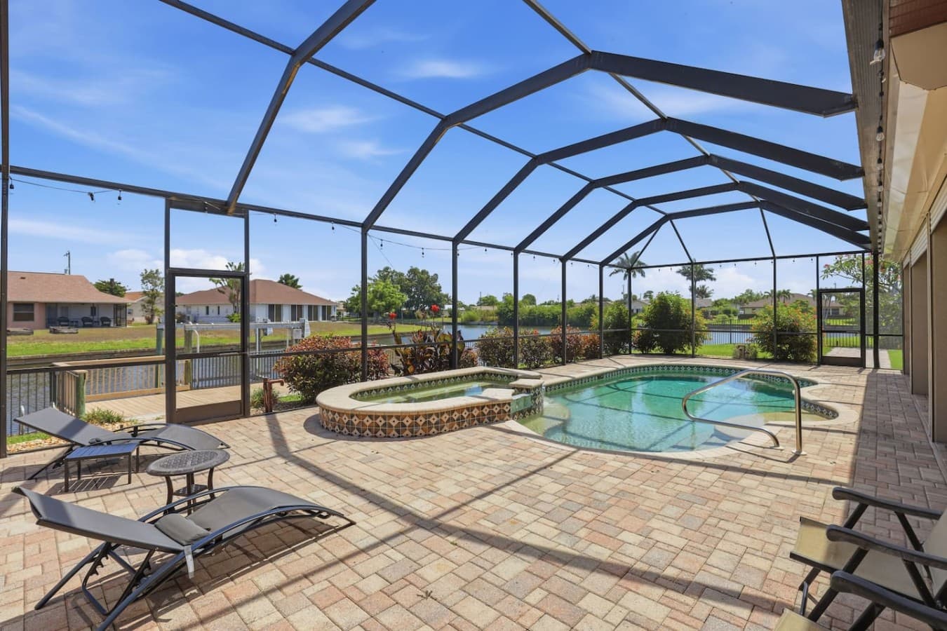 Private screened pool and spa area with peaceful waterfront views.