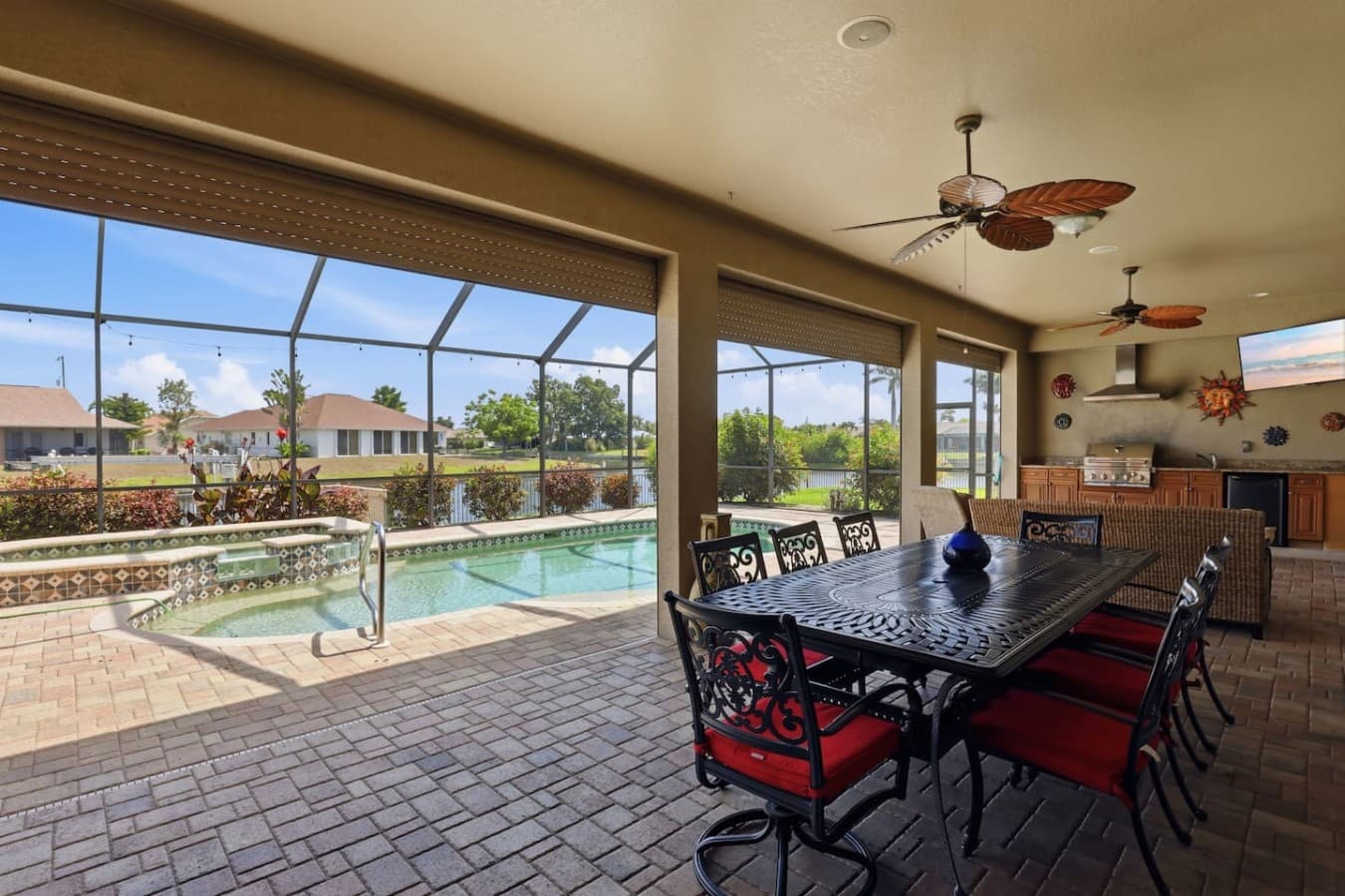 Spacious screened patio with direct access to the pool and outdoor seating areas.