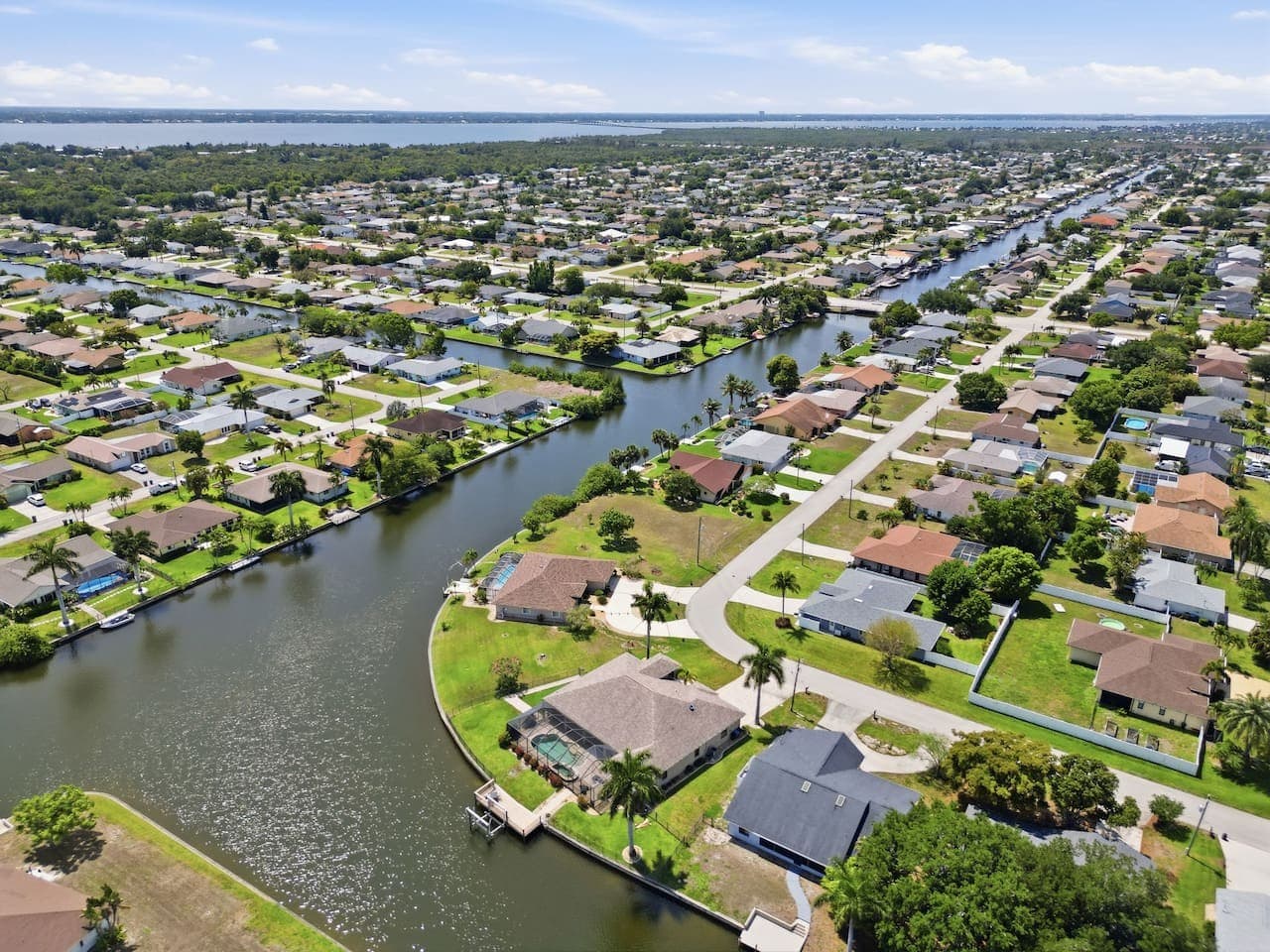 Aerial neighborhood views showcasing the waterfront canal location and surrounding homes.