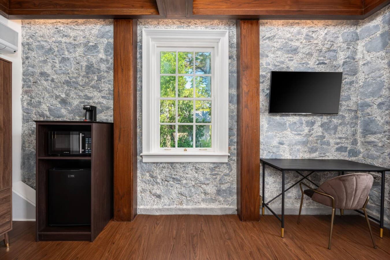 This is the private room you will be renting featuring stone walls, a mounted TV, and a dedicated workspace for added convenience.