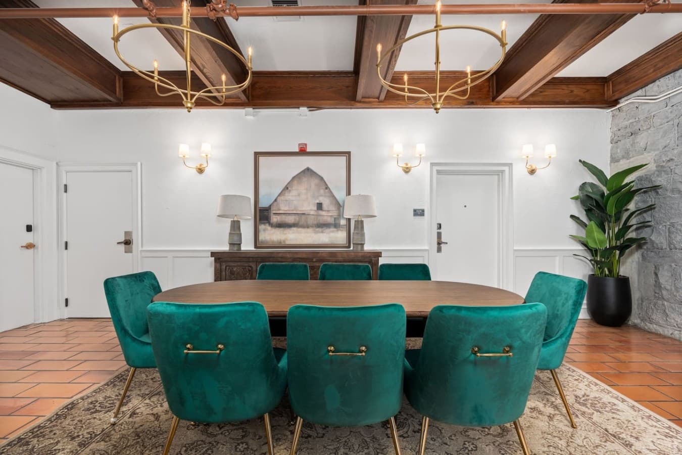 A refined shared dining room with elegant lighting and plush seating located in the hotel’s common area and not inside your private room.