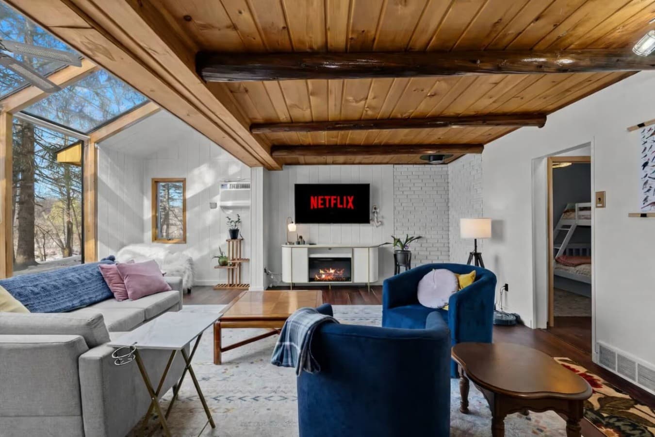 Cozy living room with warm wood ceilings and comfortable seating.