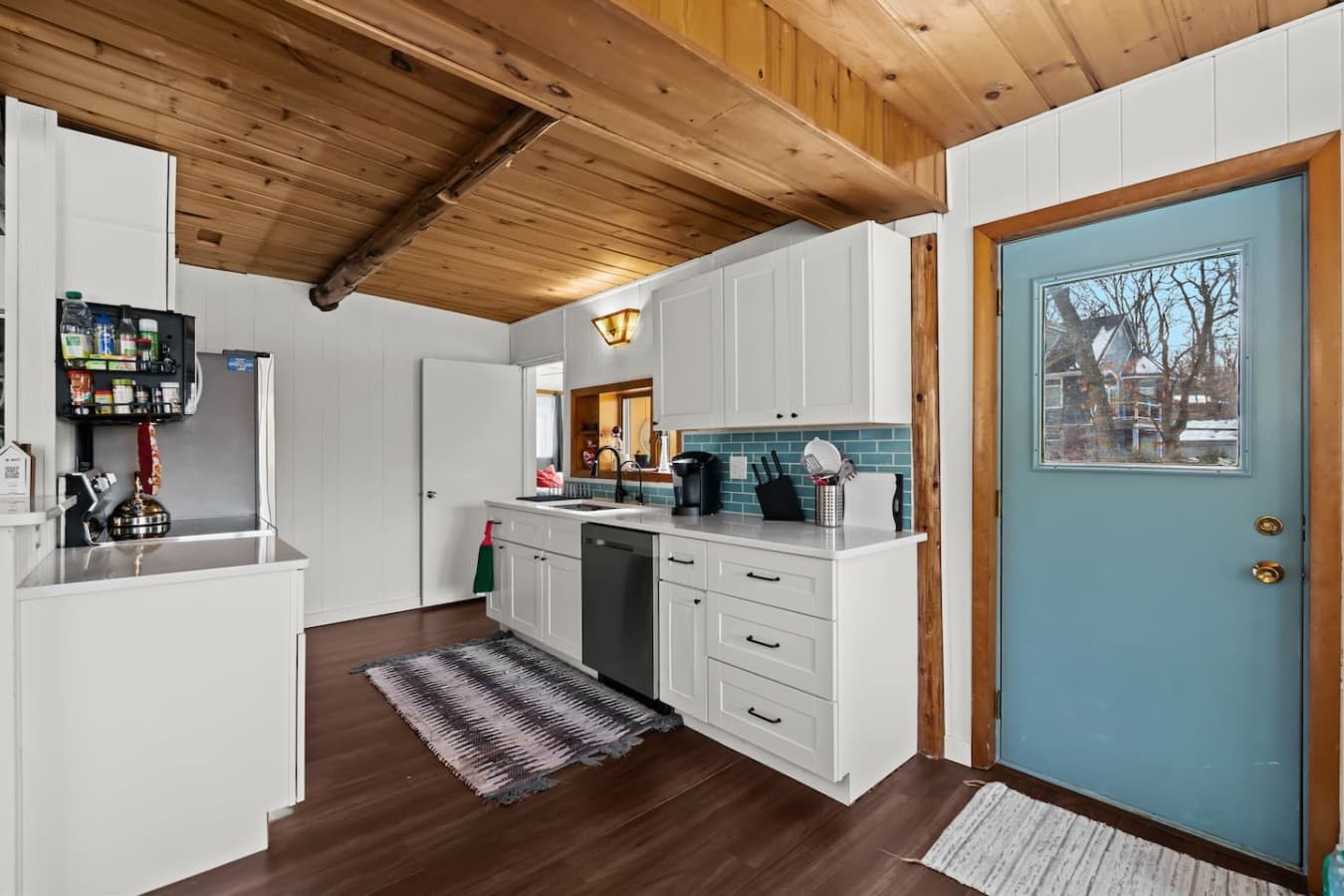 Bright kitchen with modern cabinets and warm wood ceilings.