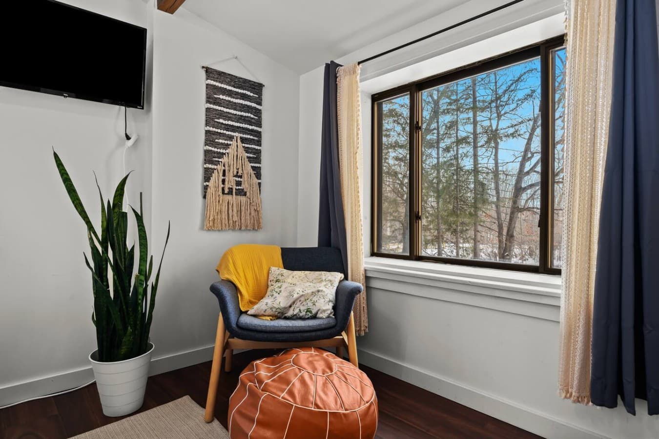 Quiet reading nook with comfortable seating and forest views.