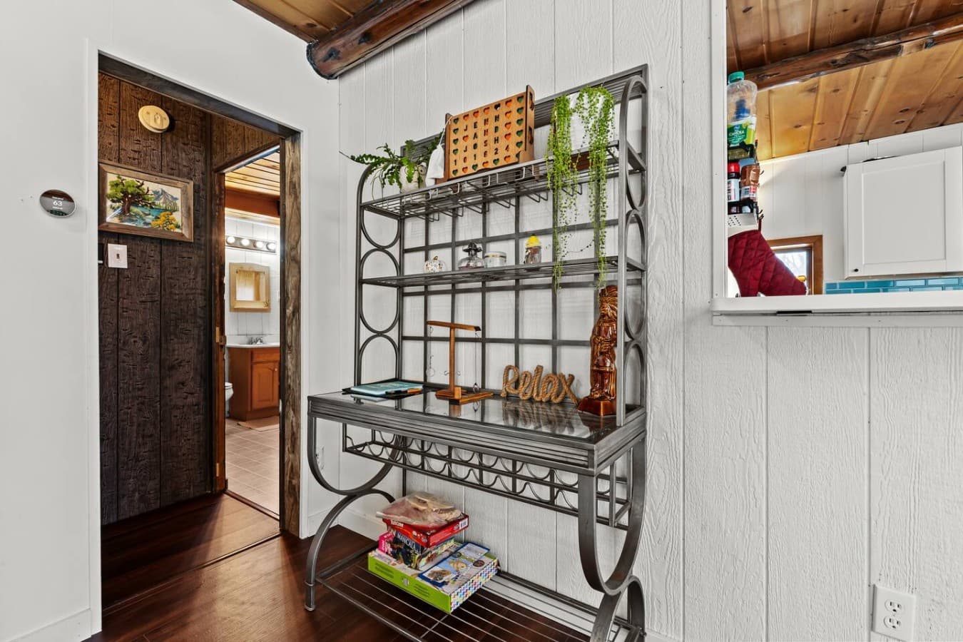 Decorative console table with shelving and charming accents.