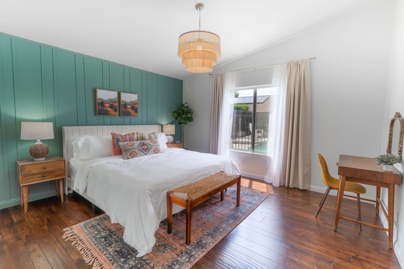 Spacious bedroom with a king bed and calming modern decor.