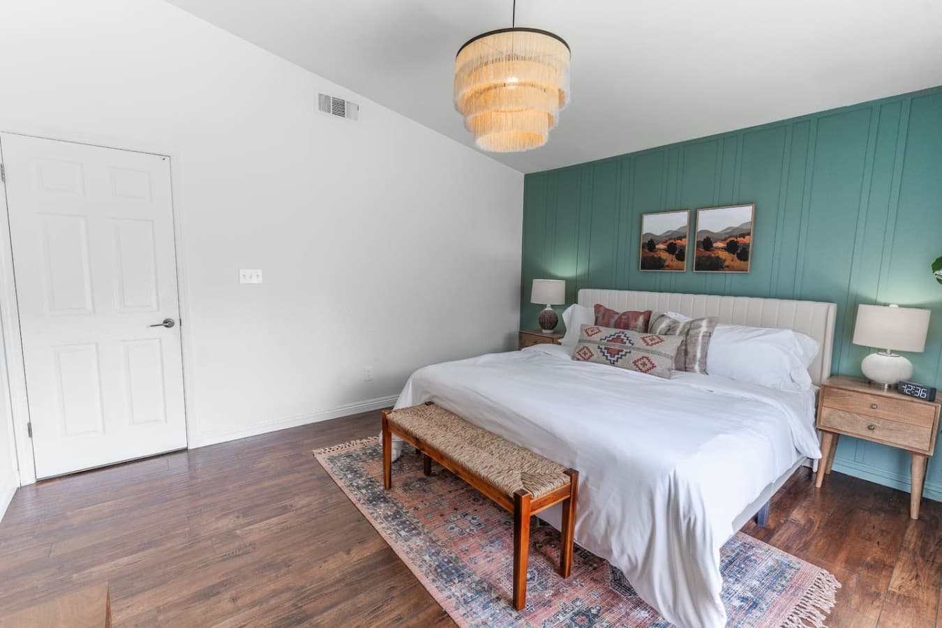 Comfortable bedroom retreat with soft lighting and hardwood floors.