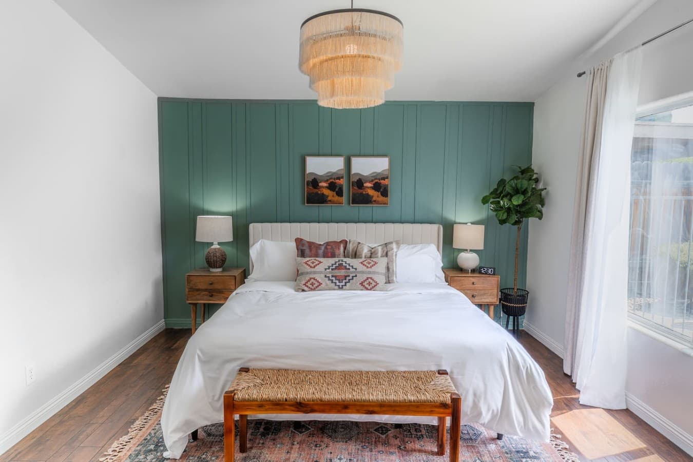 King bedroom with statement accent wall and cozy furnishings.