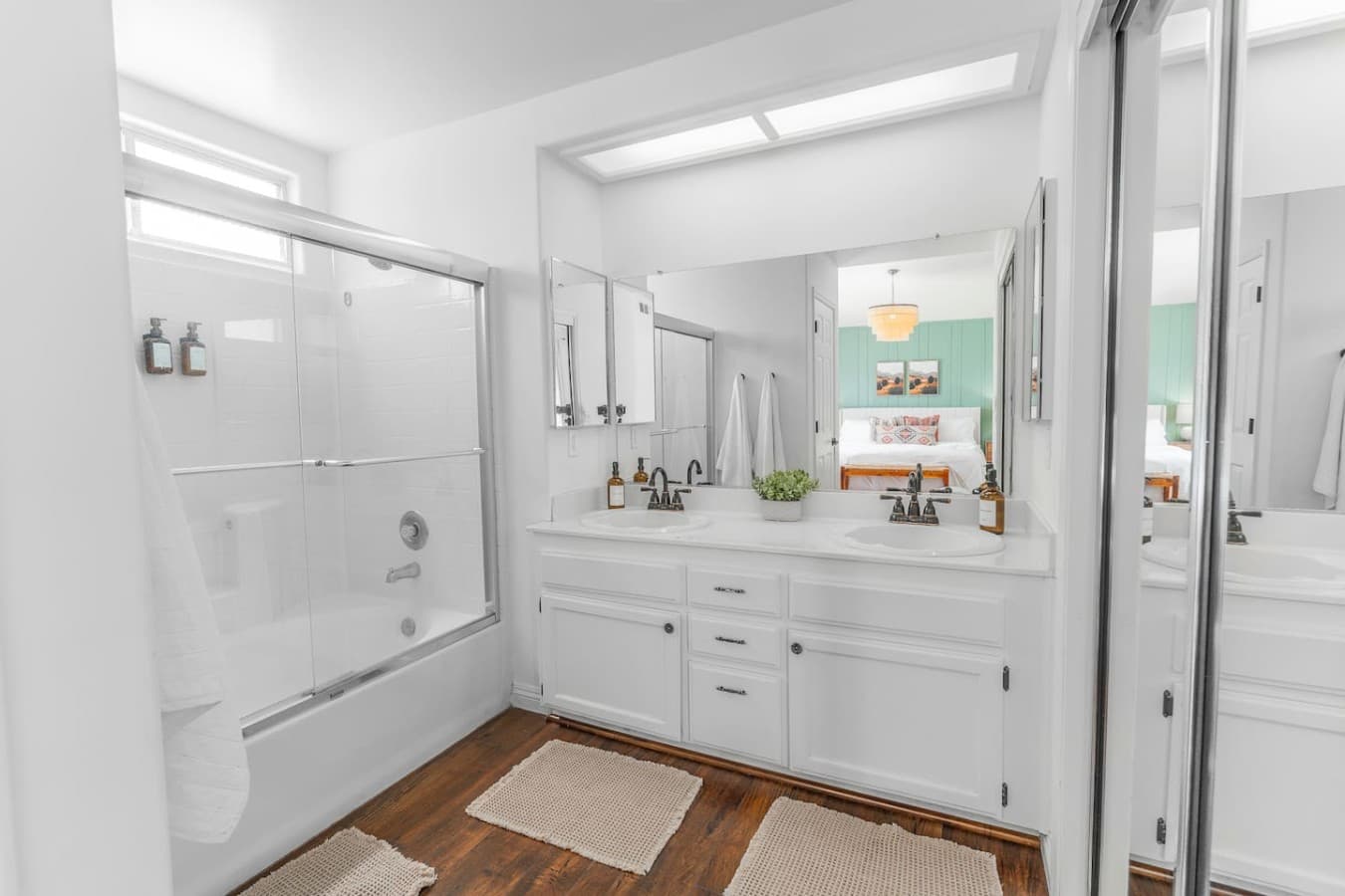 Clean and spacious bathroom with dual sinks and a large soaking tub.