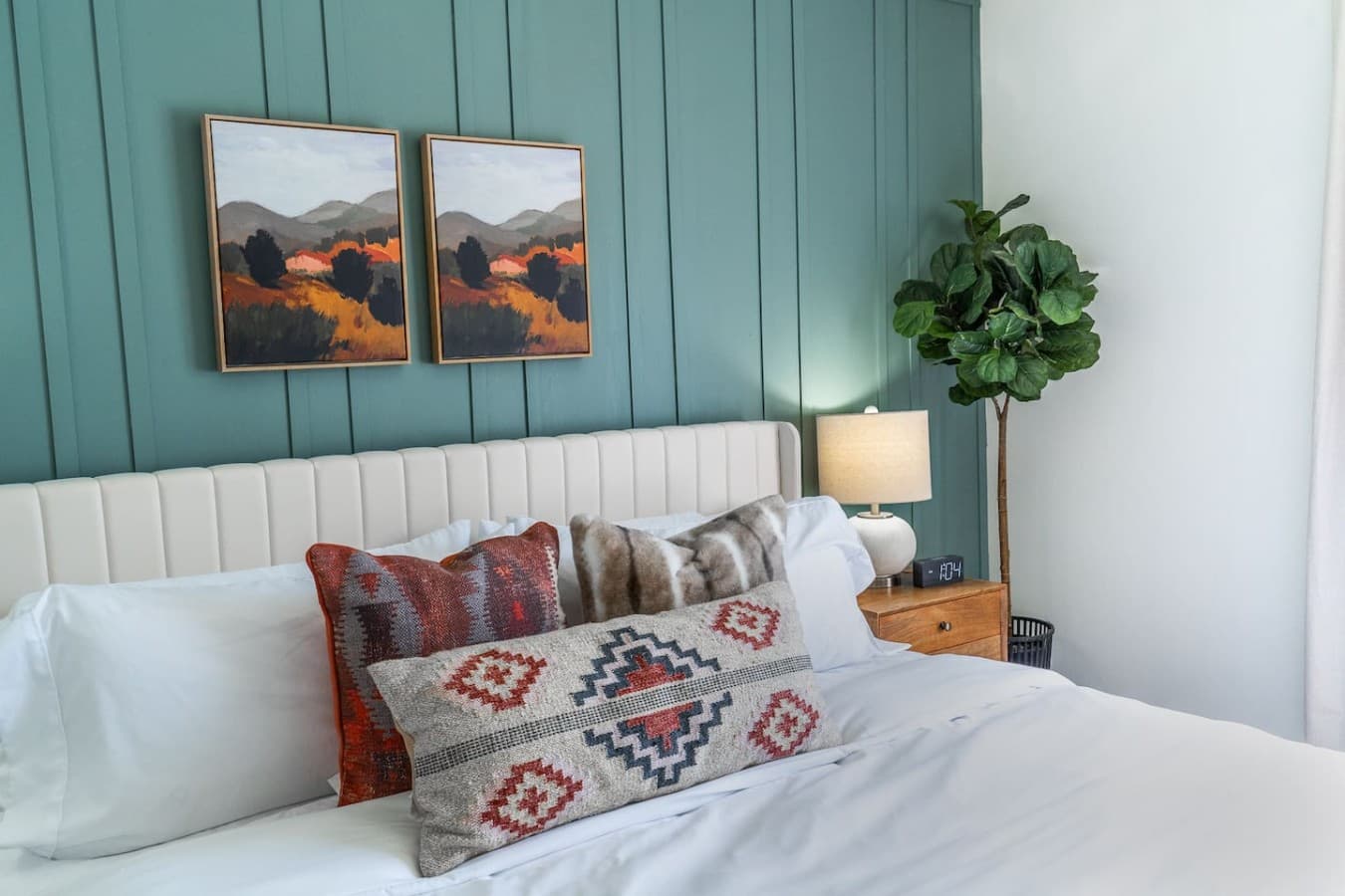 Stylish king bedroom with layered textures and modern accents.