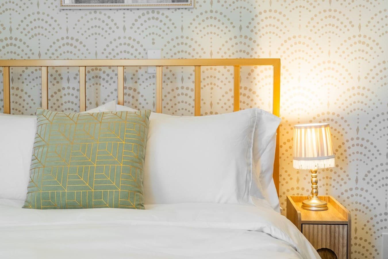 Charming bedroom with patterned wallpaper and a peaceful atmosphere.