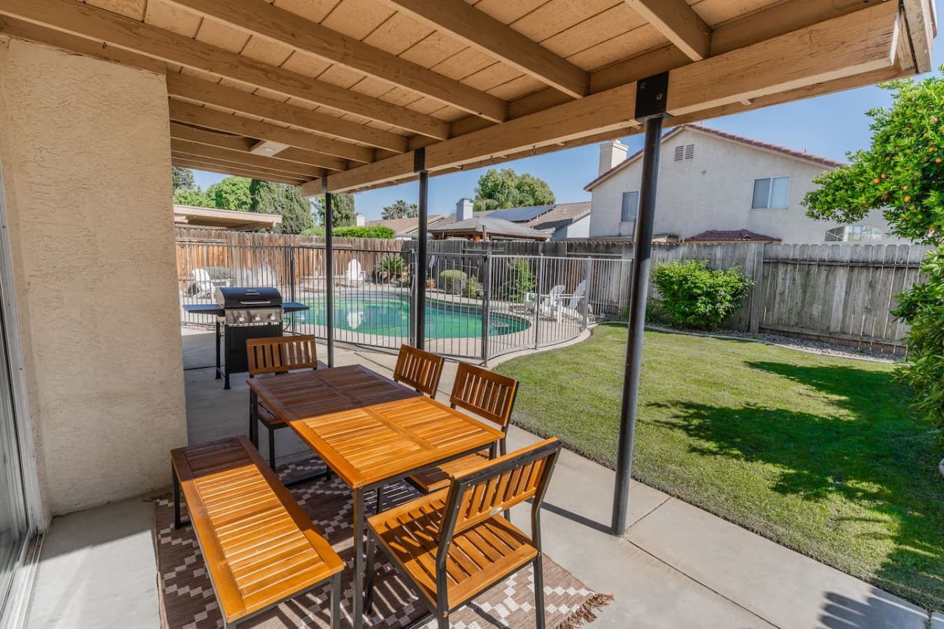 Covered outdoor dining area perfect for meals by the pool.