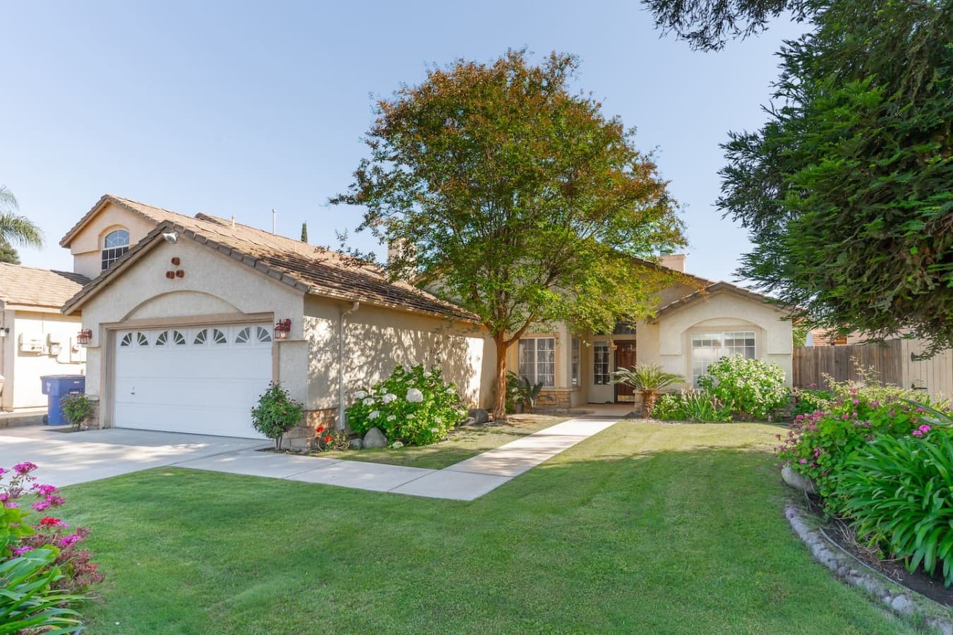 Welcoming exterior with landscaped yard and peaceful neighborhood charm.