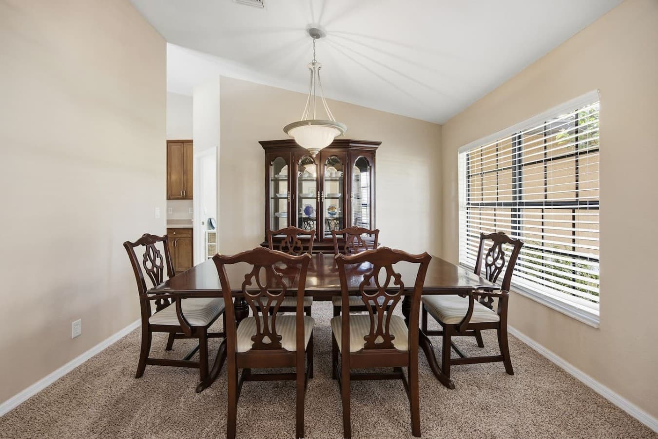 Spacious dining area featuring a classic dining set and built-in china cabinet.