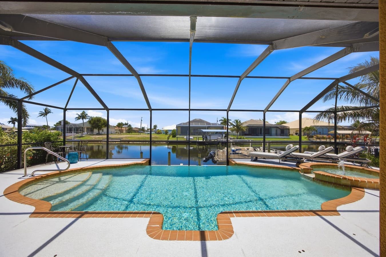 Screened pool with tranquil waterfront views and plenty of space for outdoor relaxation.