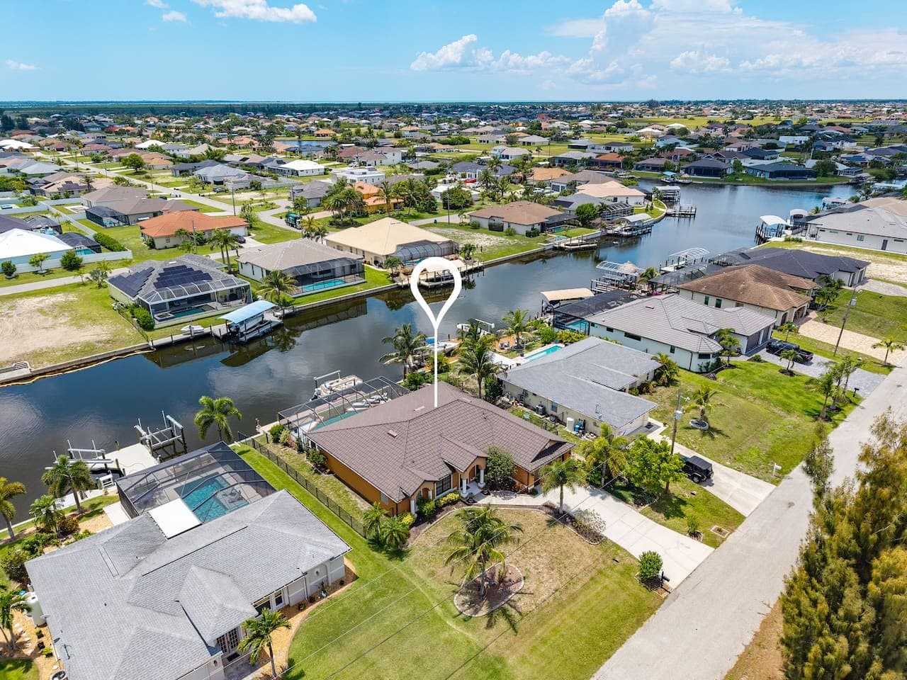 Bird's-eye view of the waterfront property with direct canal access and scenic surroundings.
