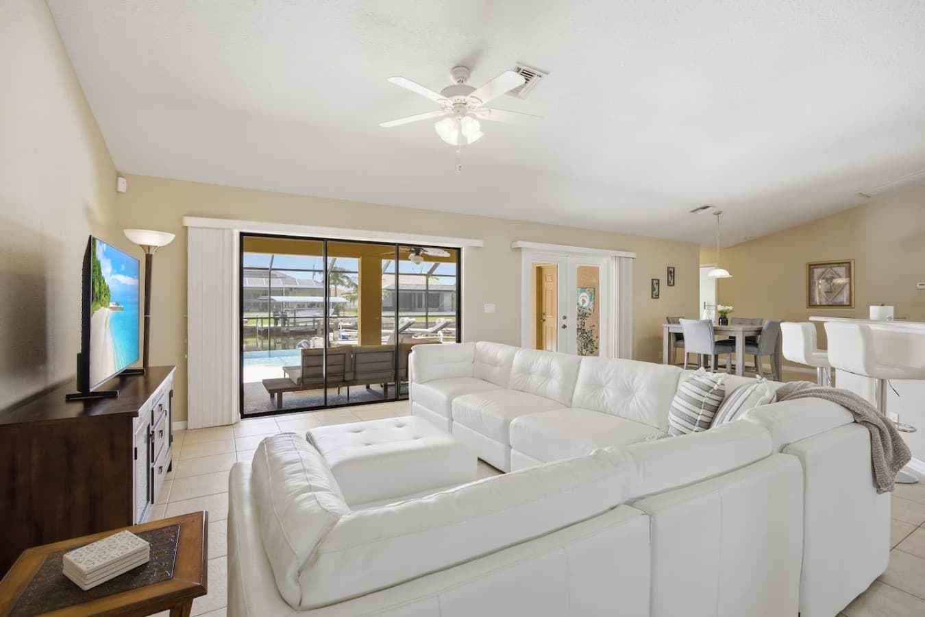 Bright and inviting living room with large sliding glass doors opening to the lanai.