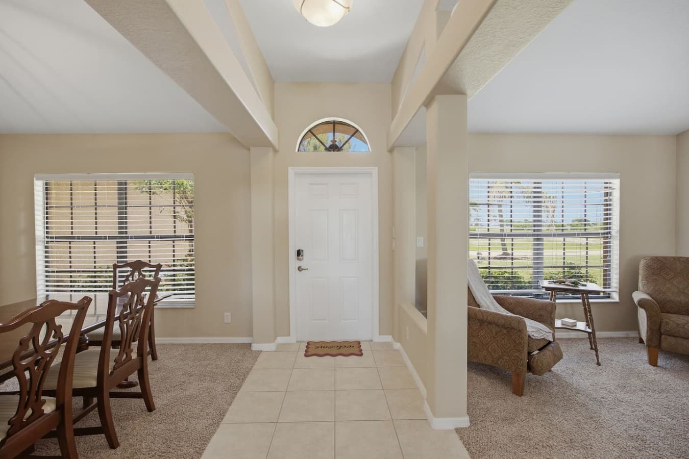 Welcoming entryway with soaring ceilings and an open layout filled with natural light.