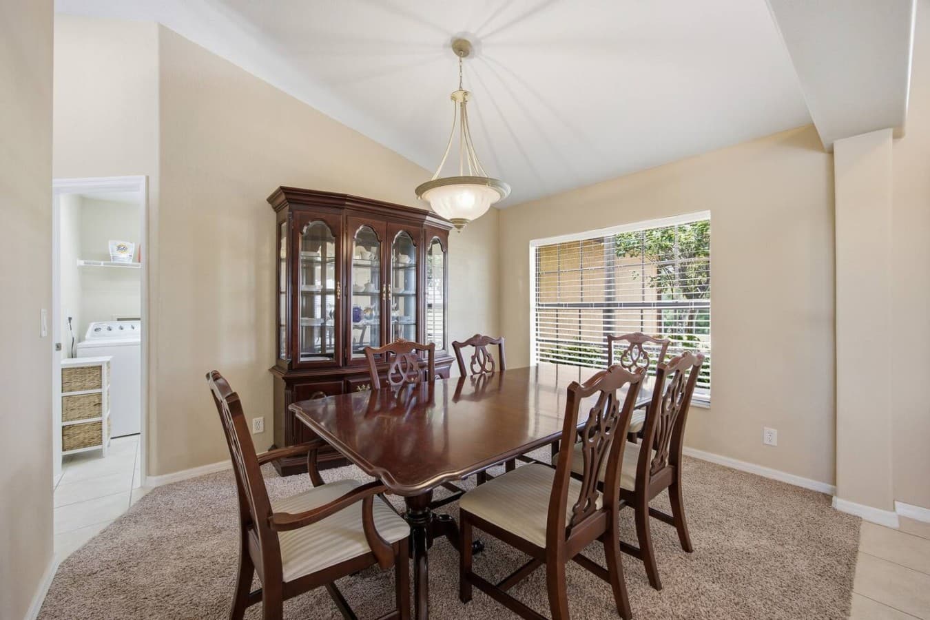 Elegant formal dining room with large windows and abundant natural light.