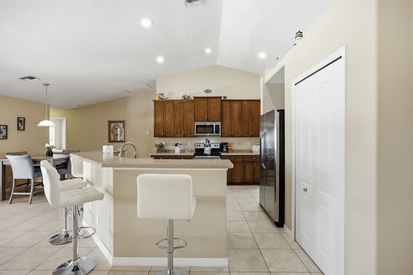 Modern kitchen with a breakfast bar, ample cabinetry, and vaulted ceilings.