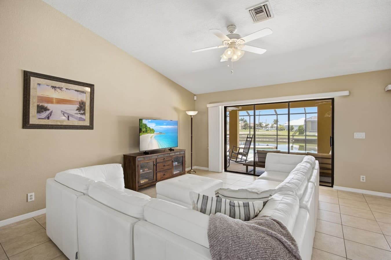 Comfortable living area with a TV and relaxing views through the patio doors.