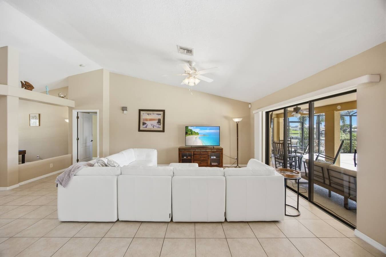 Rear view of the spacious living room showcasing ample seating and natural light.