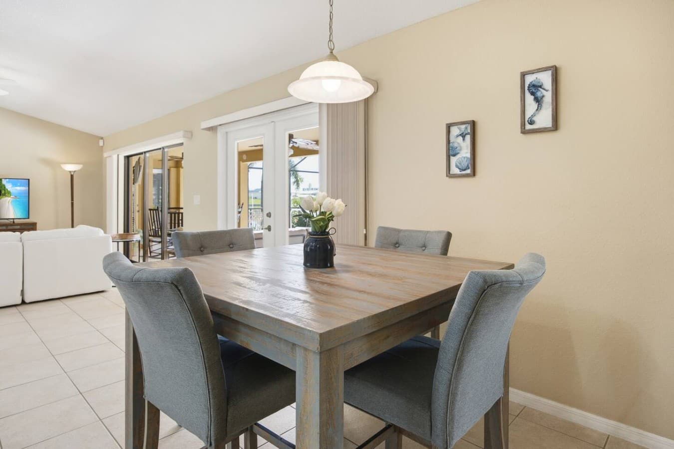 Dining area with stylish seating and easy access to the covered lanai.