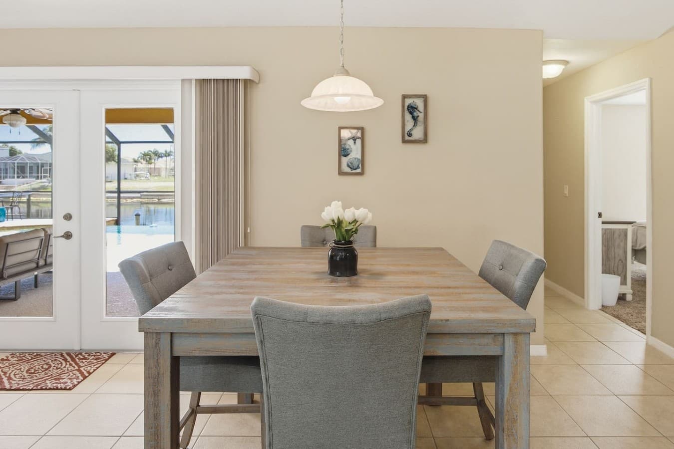 Bright dining space featuring a modern table, comfortable seating, and patio views.