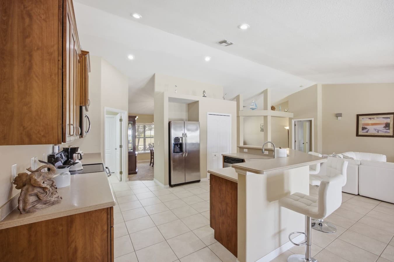 Bright open kitchen with stainless steel appliances and generous counter space.