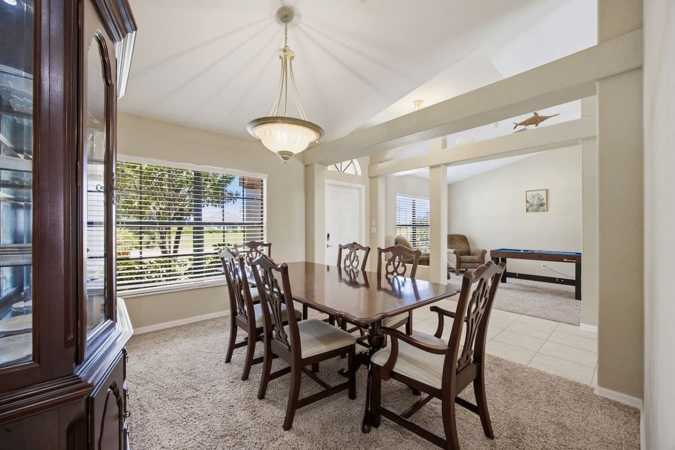 Bright dining room with an open layout connecting to the adjacent living spaces.