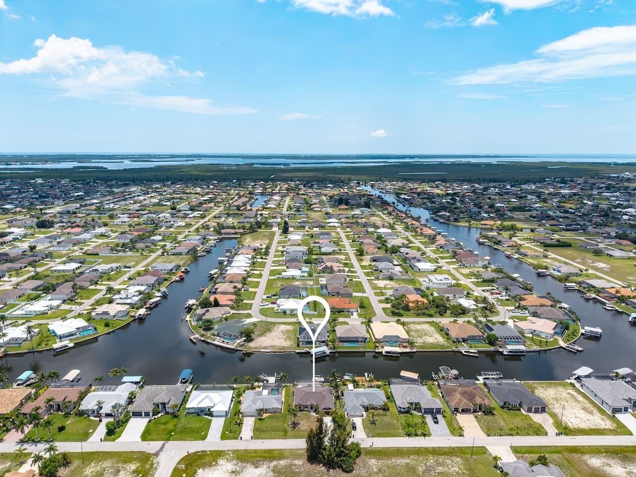 Aerial view highlighting the home's waterfront location and extensive canal network.