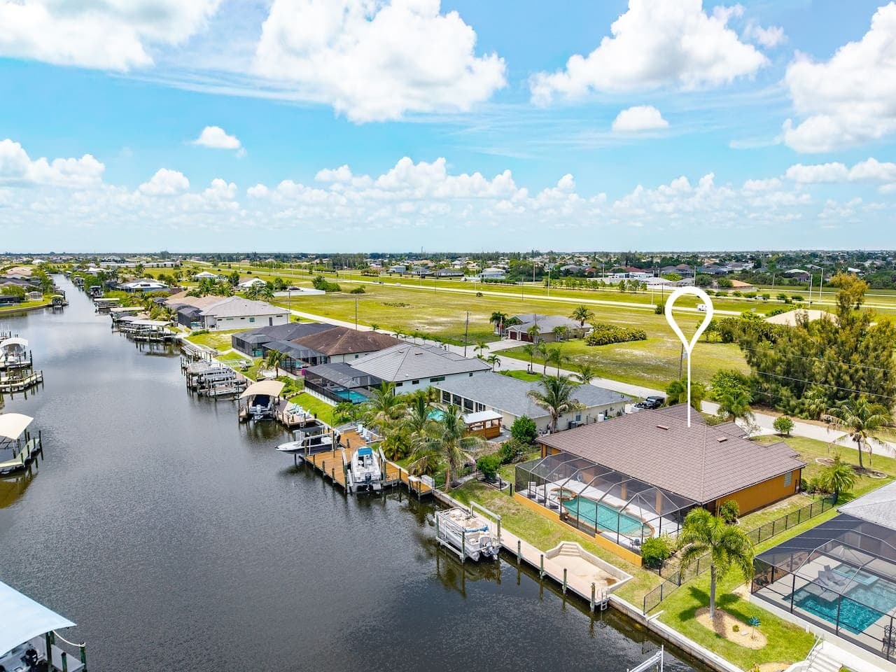 Stunning waterfront perspective featuring the private dock and direct boating access.