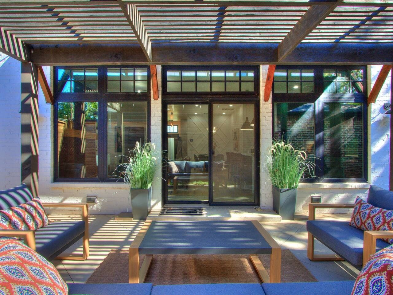 Shaded patio with comfortable outdoor seating just steps from the main living space.