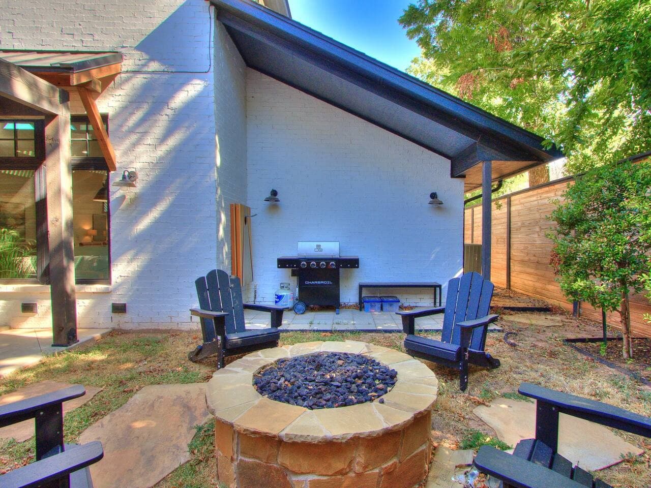 Gather around the outdoor fire pit with Adirondack seating for relaxed evenings under the trees.