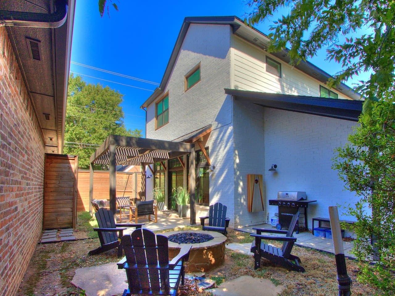 Private backyard retreat with a fire pit, outdoor seating, and multiple spaces to gather and unwind.