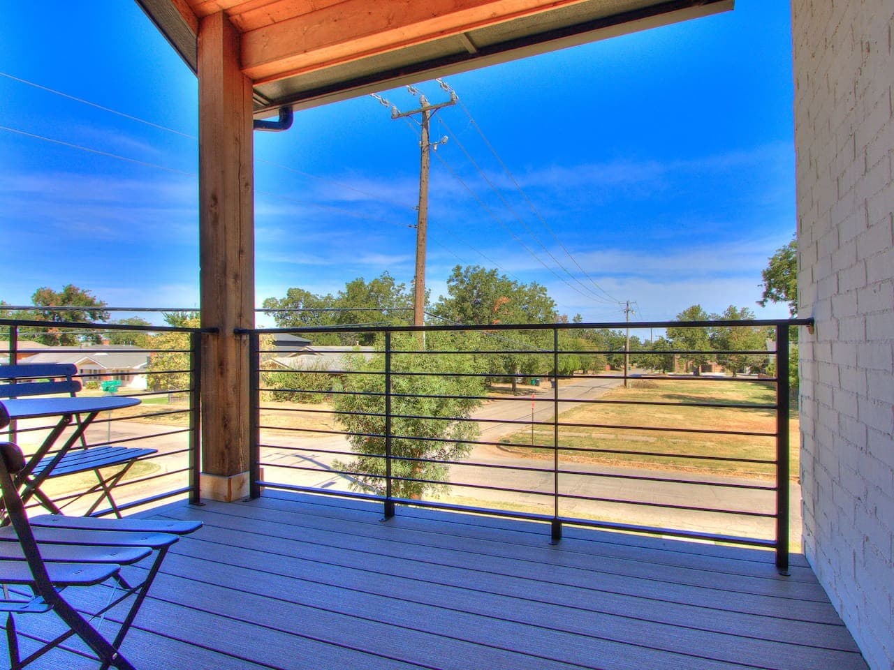 Private upper level balcony offers a peaceful spot to step outside and enjoy the neighborhood views.