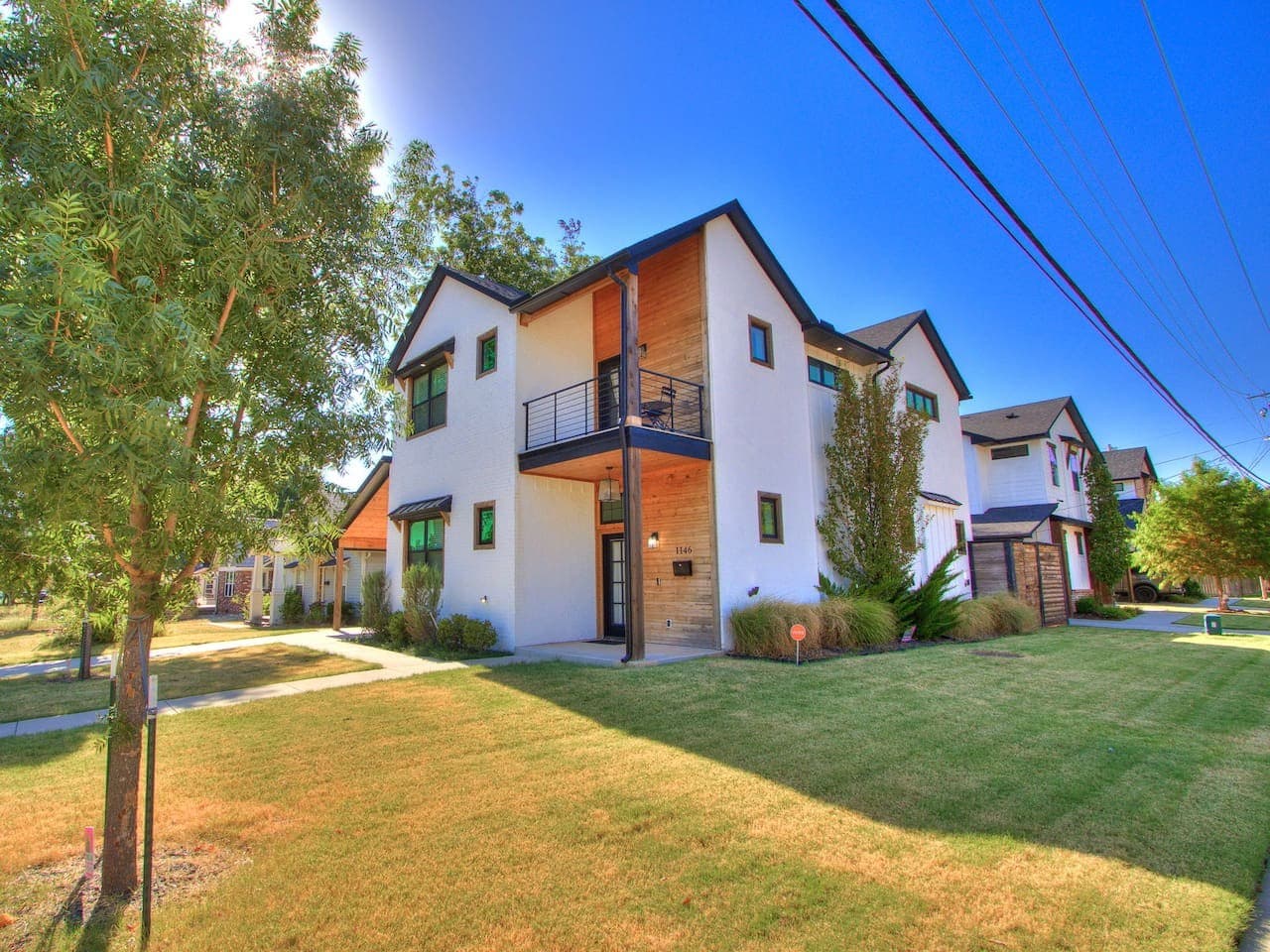 Beautiful corner property with contemporary design, a private balcony, and thoughtfully landscaped outdoor space.
