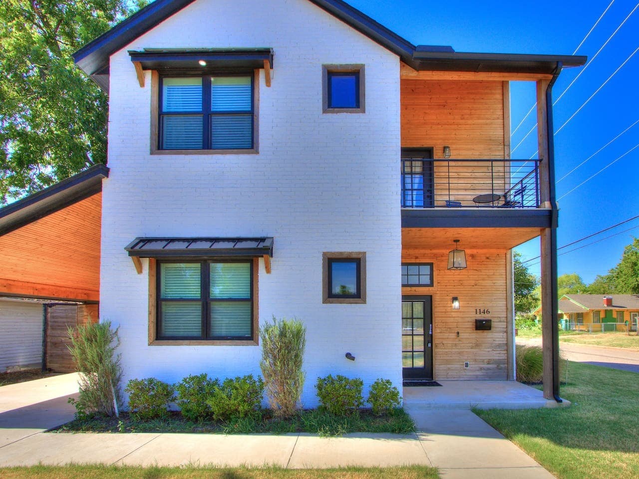 Contemporary exterior blends clean modern lines with warm natural wood details and a covered entryway.