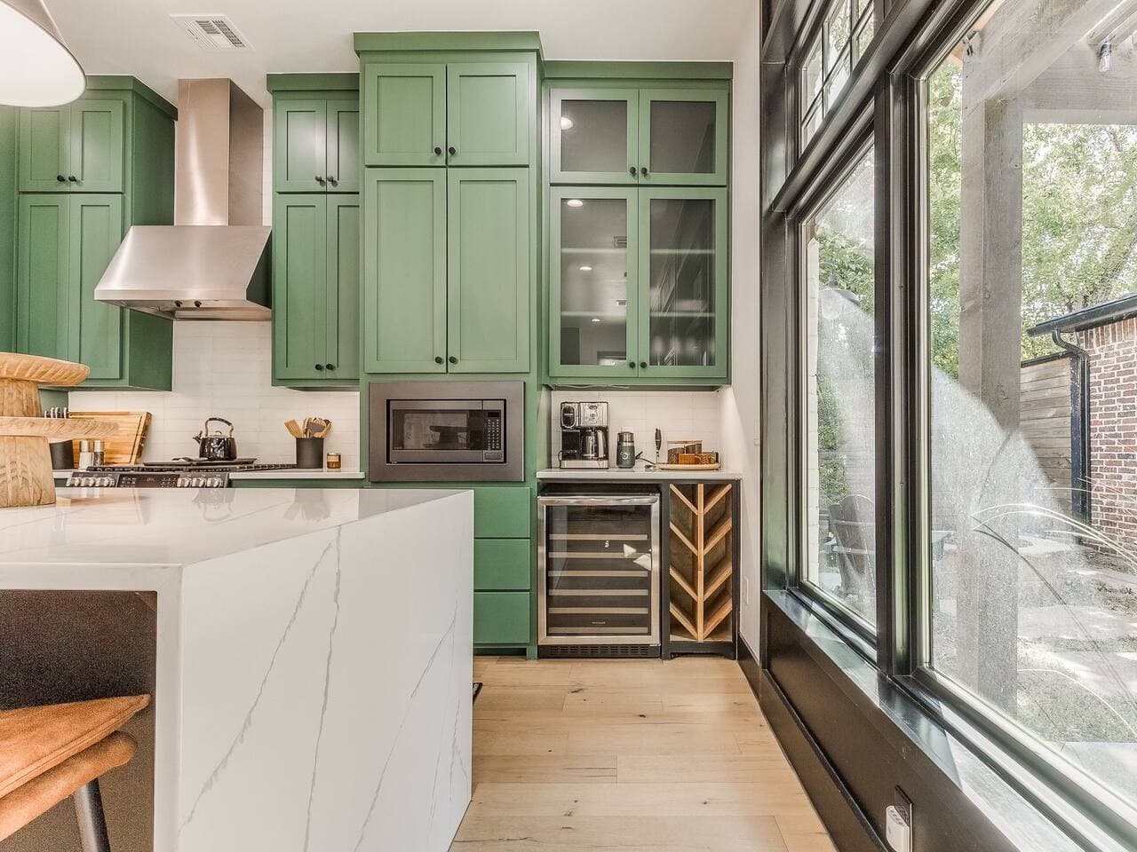 Thoughtfully designed kitchen featuring custom cabinetry, generous storage, and a built in wine refrigerator.