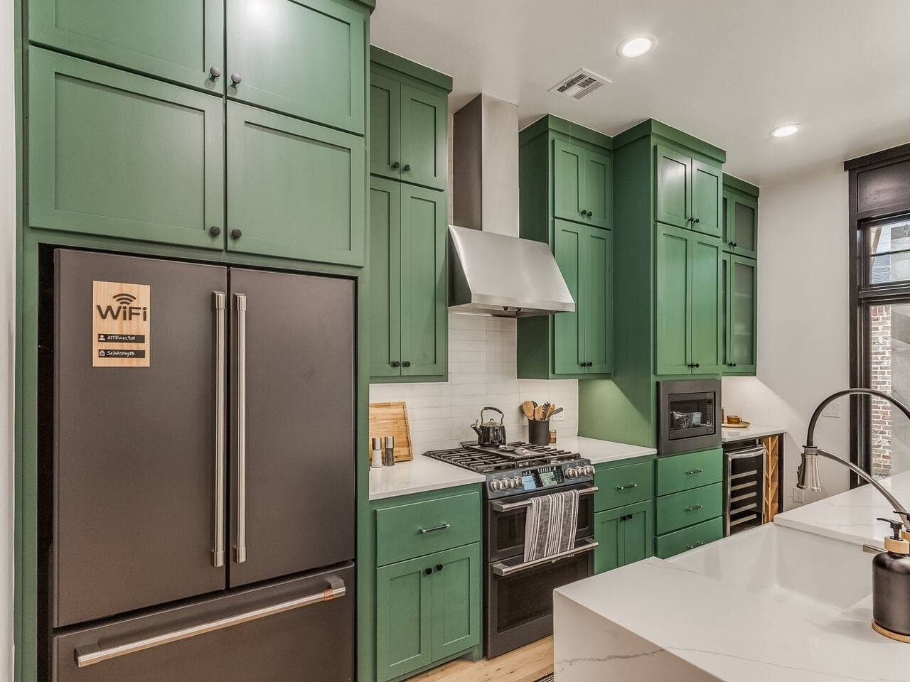Fully equipped kitchen with stainless steel appliances, ample cabinetry, and a professional style range.