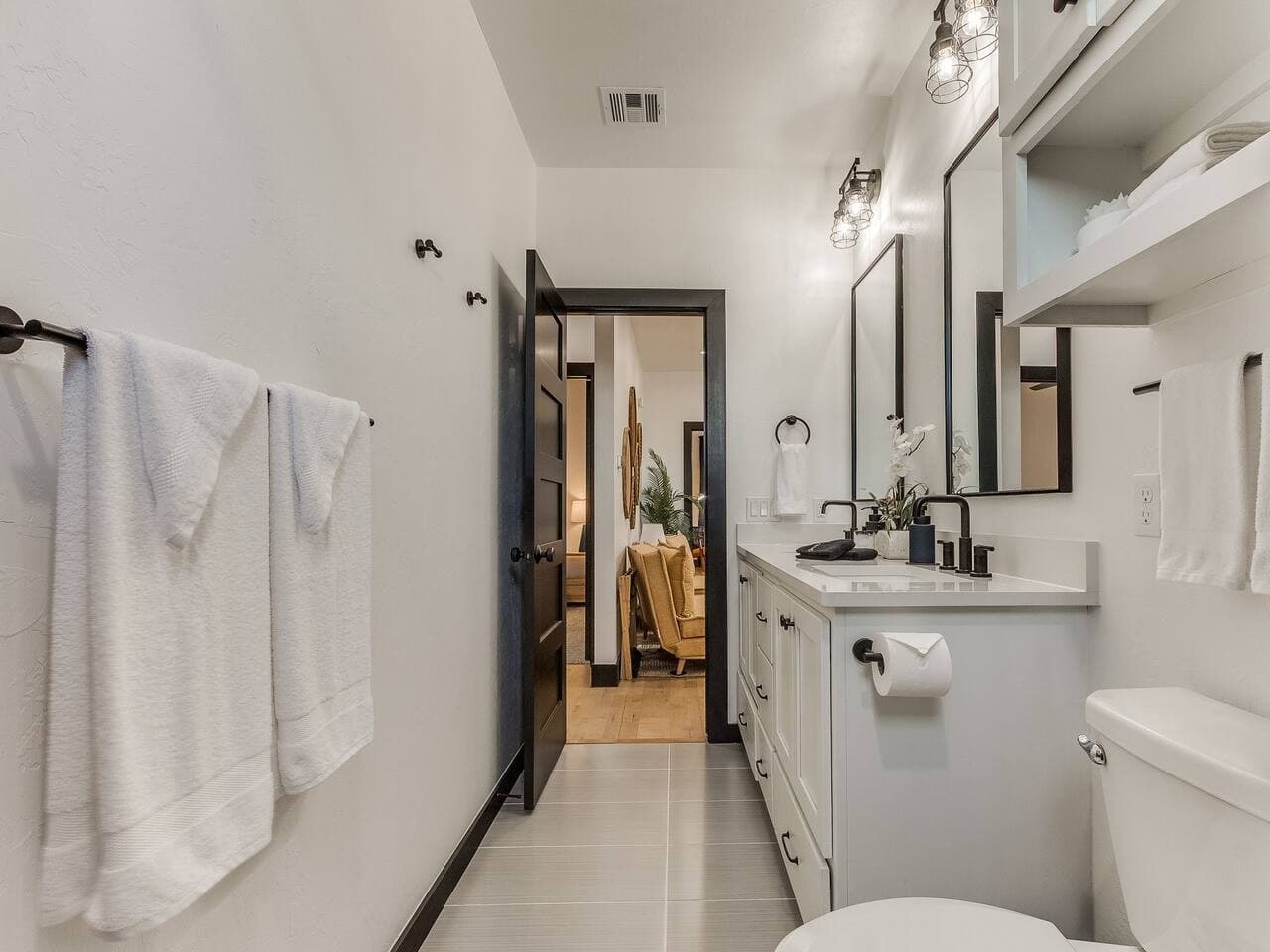 Well appointed full bathroom with a spacious vanity, clean modern design, and plenty of room to get ready.
