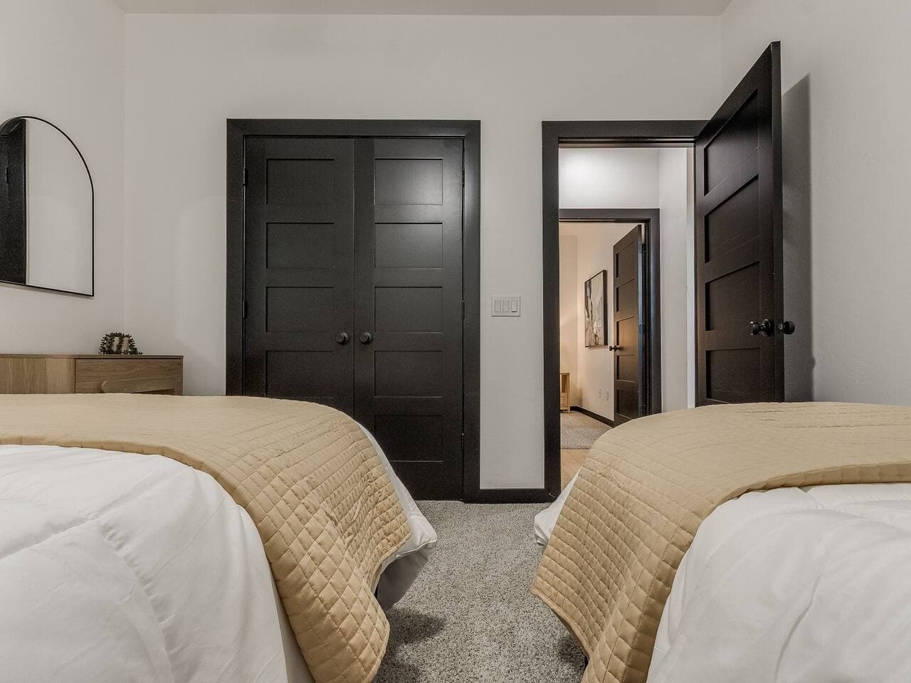 Bright and welcoming bedroom with flexible sleeping arrangements, generous closet space, and easy access to the hallway.