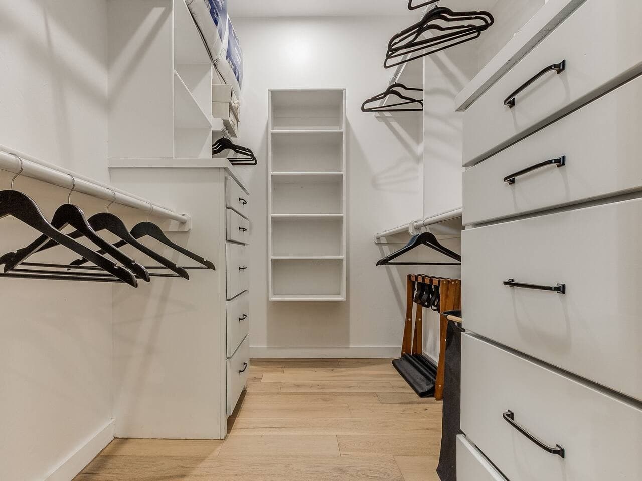 Generous walk in closet with built in drawers, shelving, and ample hanging space for longer stays.