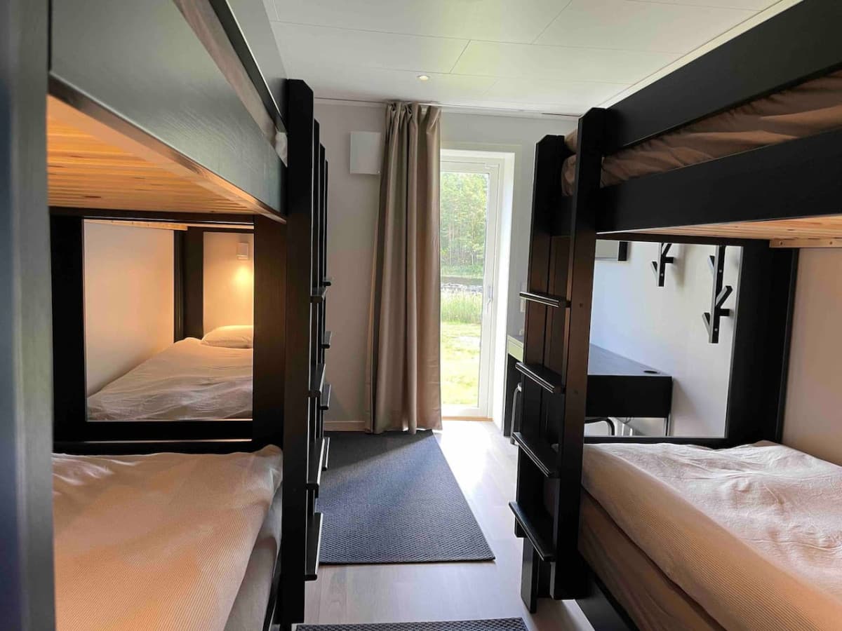 Bedroom with several beds with view of lake