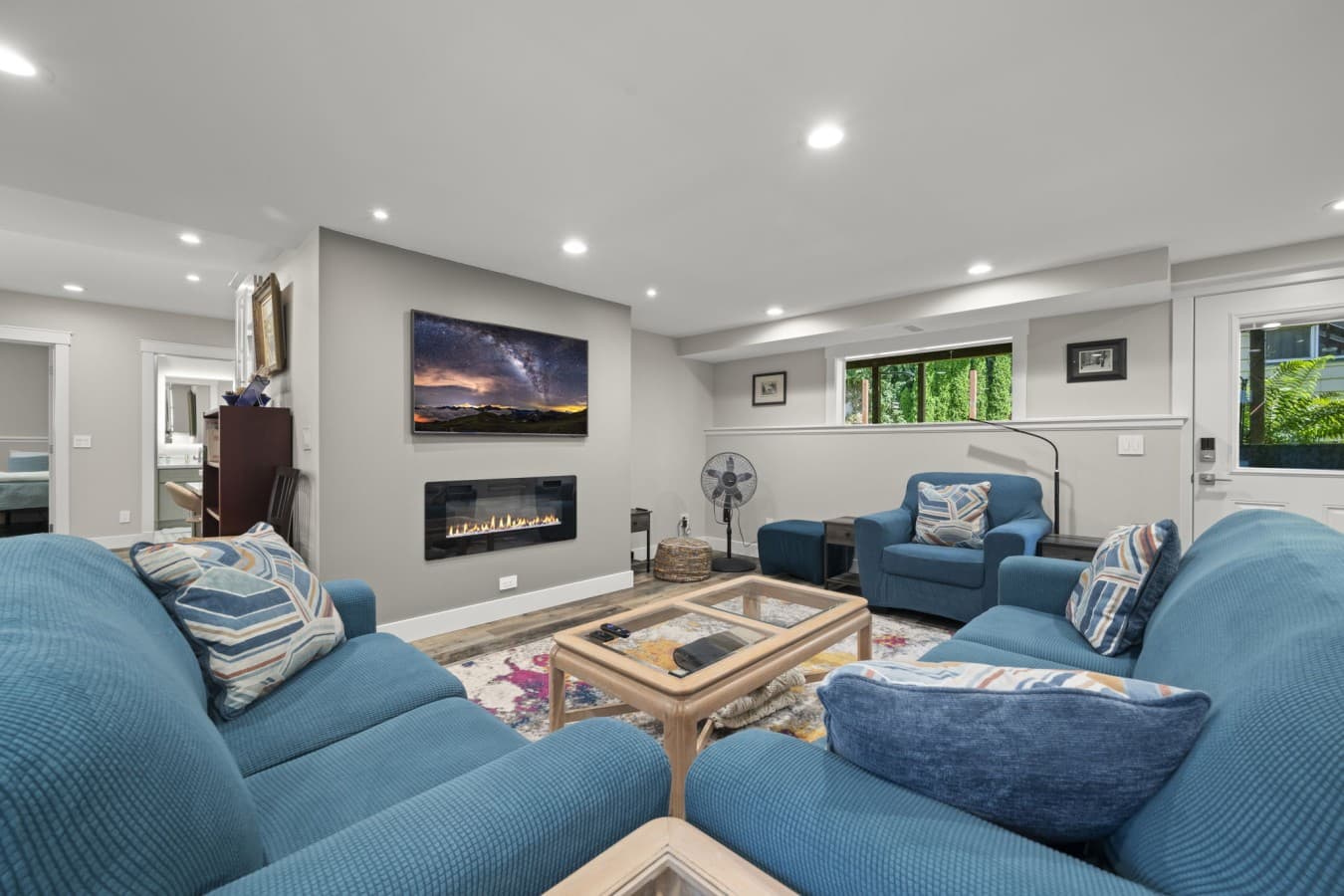Open and welcoming living space featuring a Smart TV, electric fireplace, and easy access to the kitchen_.jpg
