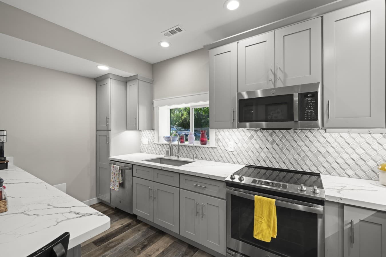 Modern cooking area featuring a full-size range, microwave, and ample cabinet storage_.jpg