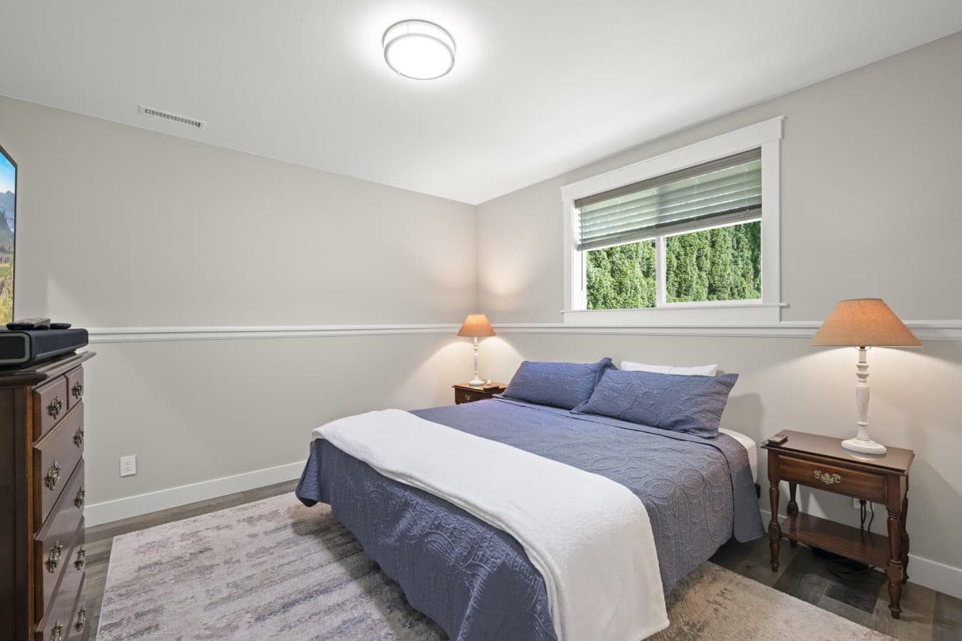 Primary bedroom with a comfortable queen-size bed, soft linens, bedside tables, and natural light_.jpg