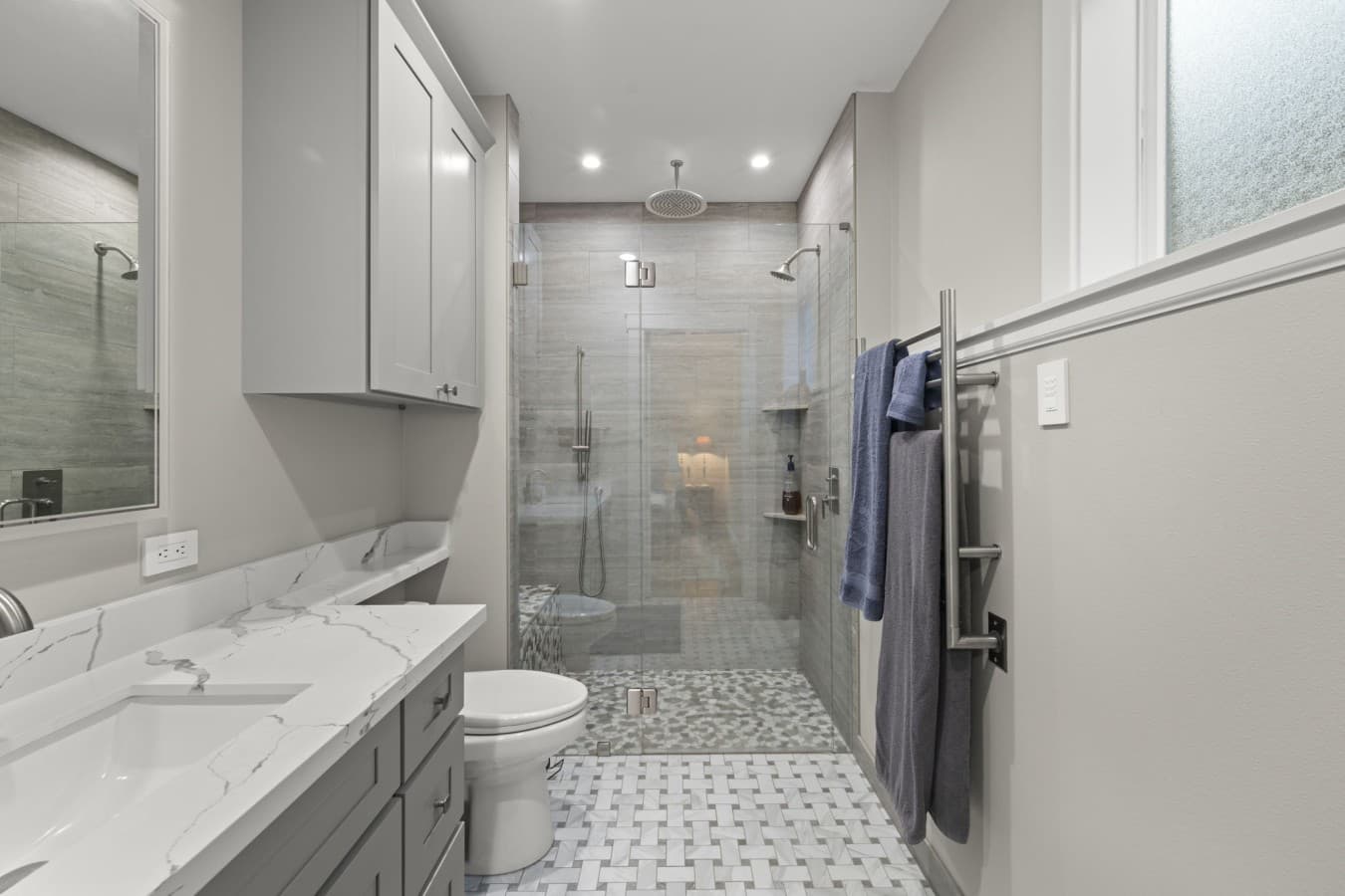 Modern ensuite bathroom offering ample storage, a double vanity, and a spacious walk-in shower_.jpg